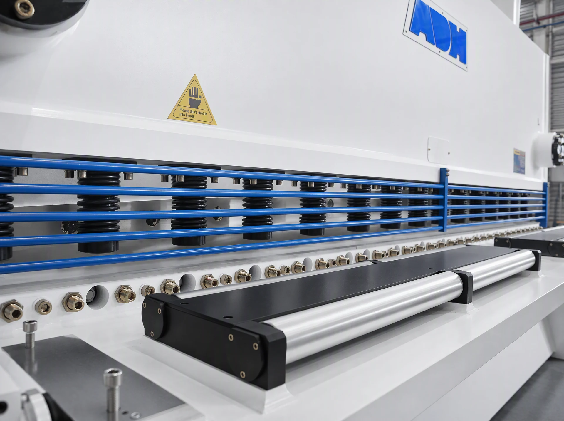 Guillotine shear feed opening, hold-downs, front support and guard rails