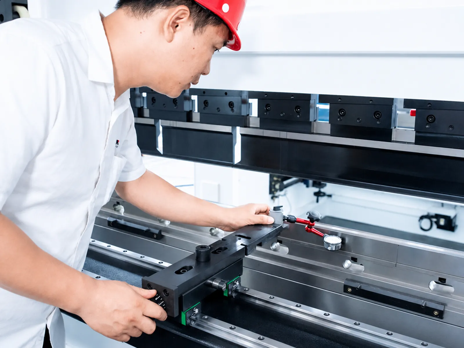 Technician inspecting the working area of a press brake
