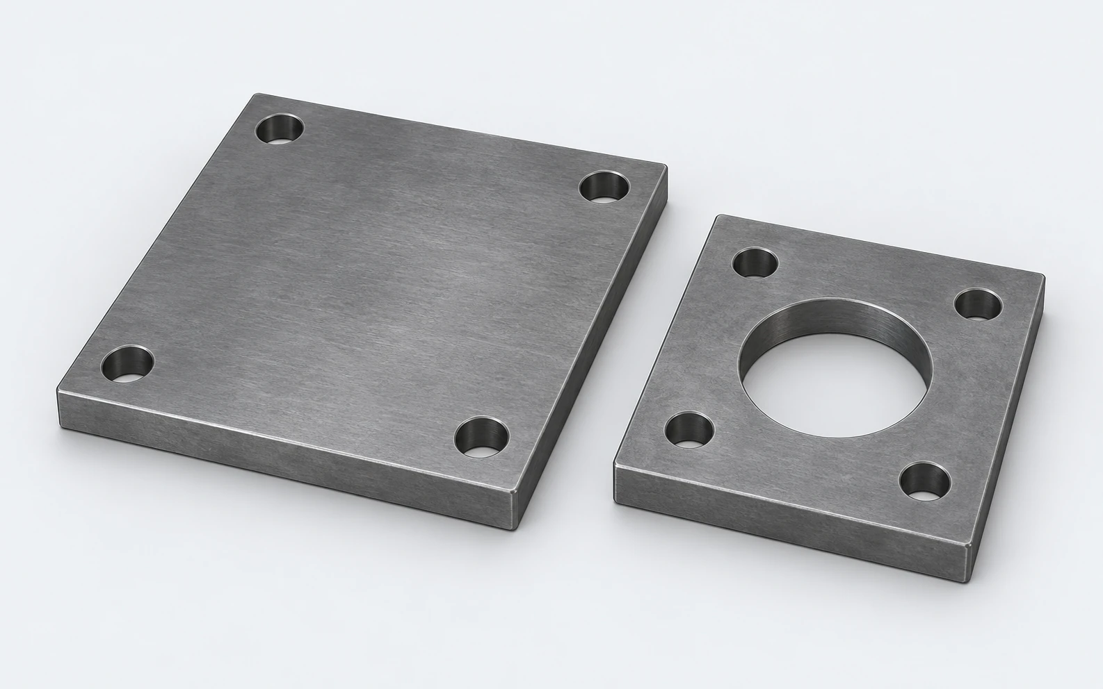 Illustration of thick rectangular steel mounting plates with fixing holes and a central opening.